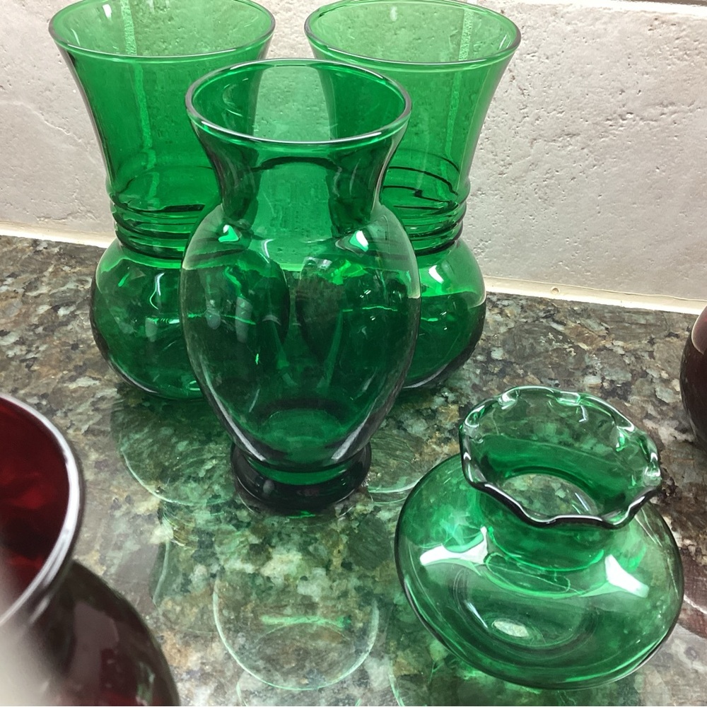 Antique green glassware (four flower vases in various sizes.)